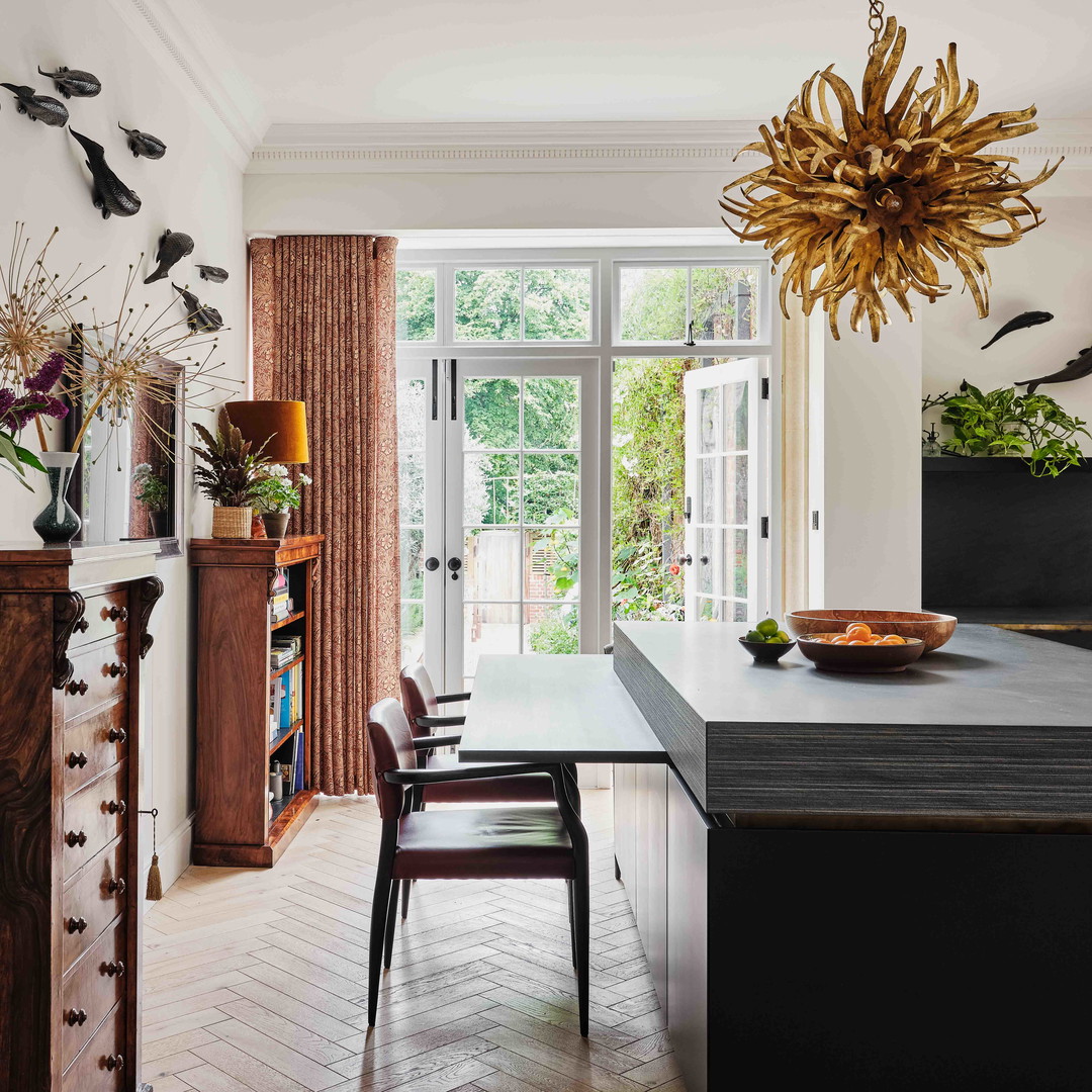 a dining room with a table, chairs and a chandelier