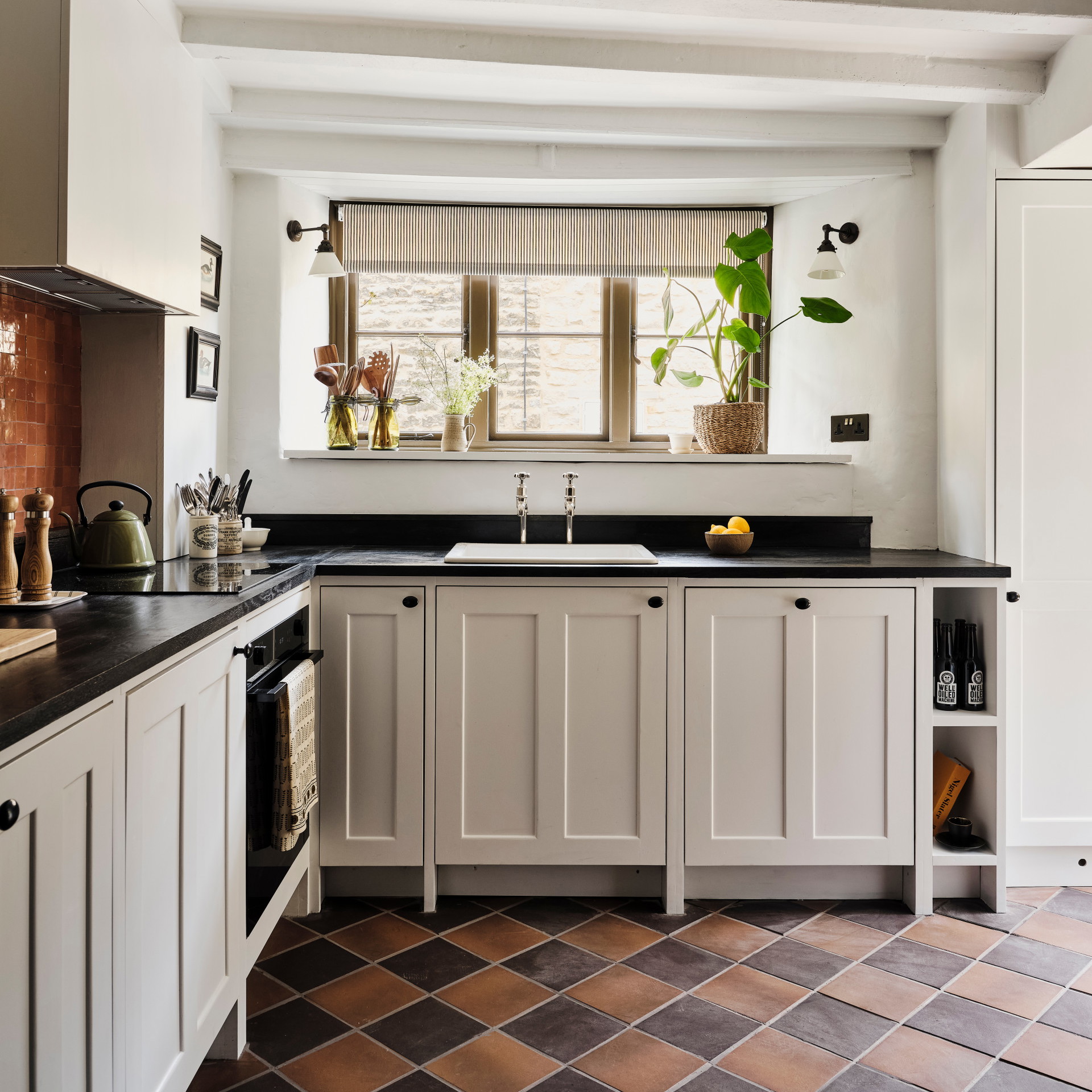 a kitchen with a black counter top and white cabinets