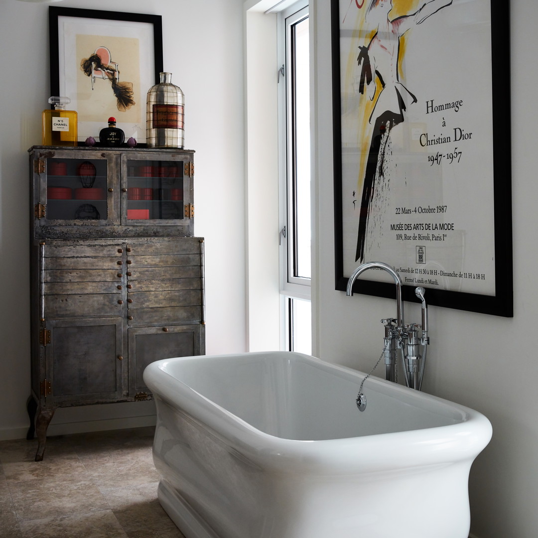 a white bath tub sitting next to a window