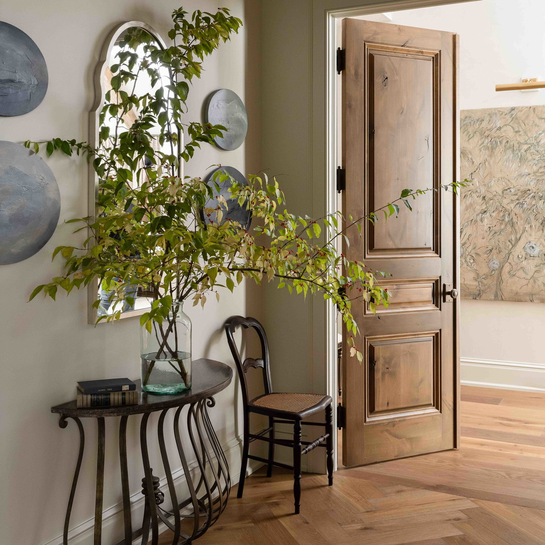 a room with a door and a table with a potted plant