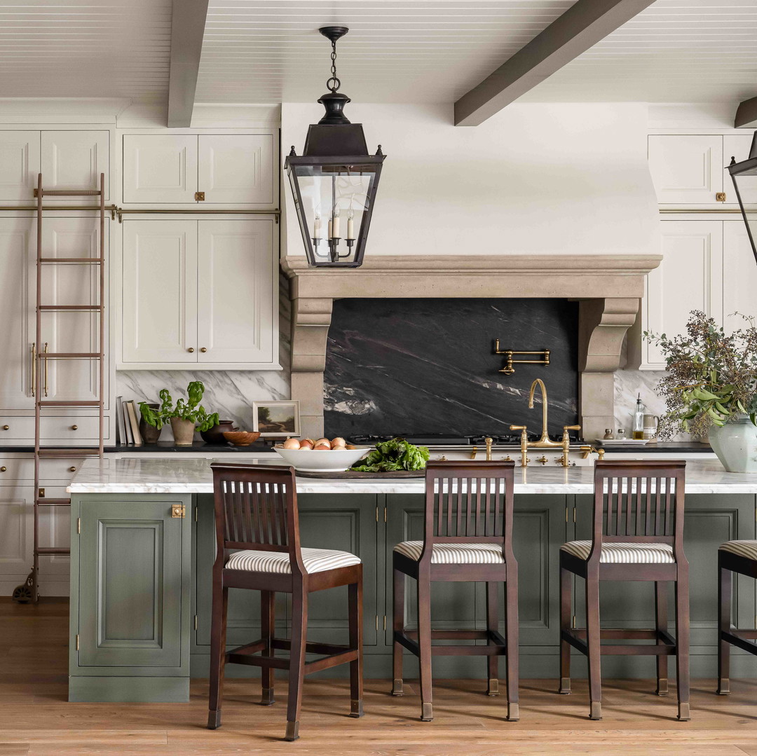 a large kitchen with a center island and wooden chairs