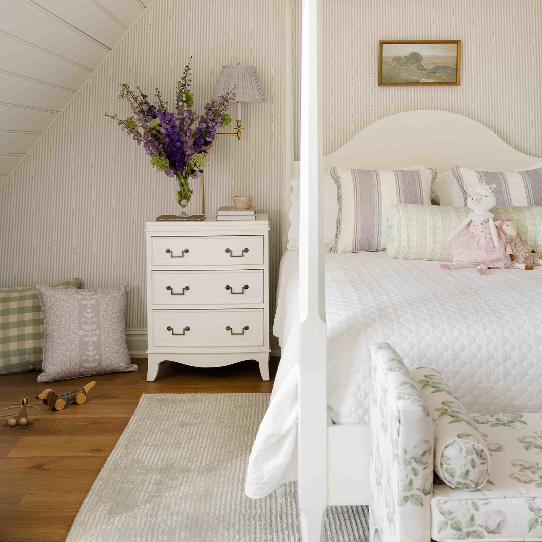 a white bed sitting in a bedroom next to a white dresser