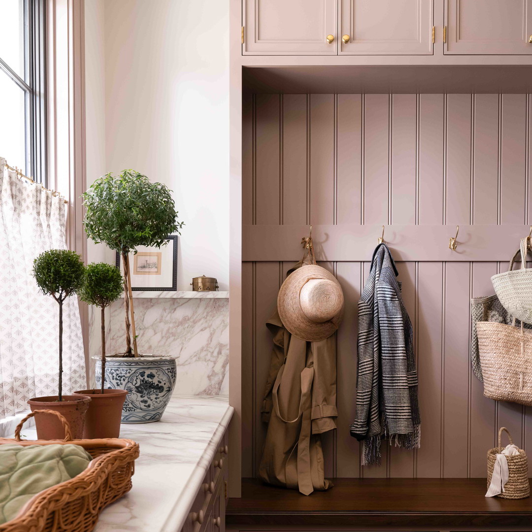 a kitchen with a lot of cabinets and a potted plant