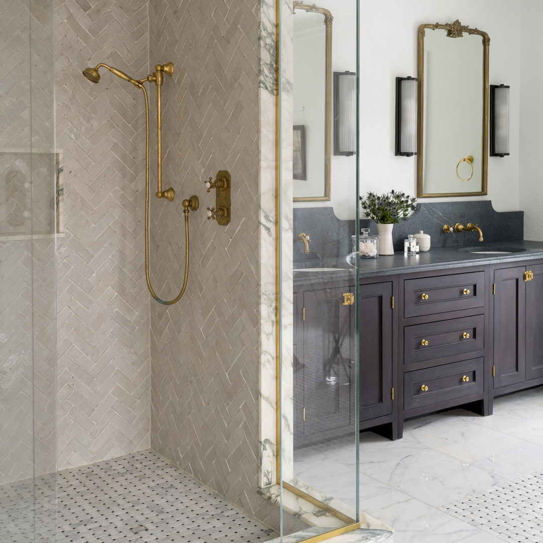 a bathroom with a walk in shower next to a sink