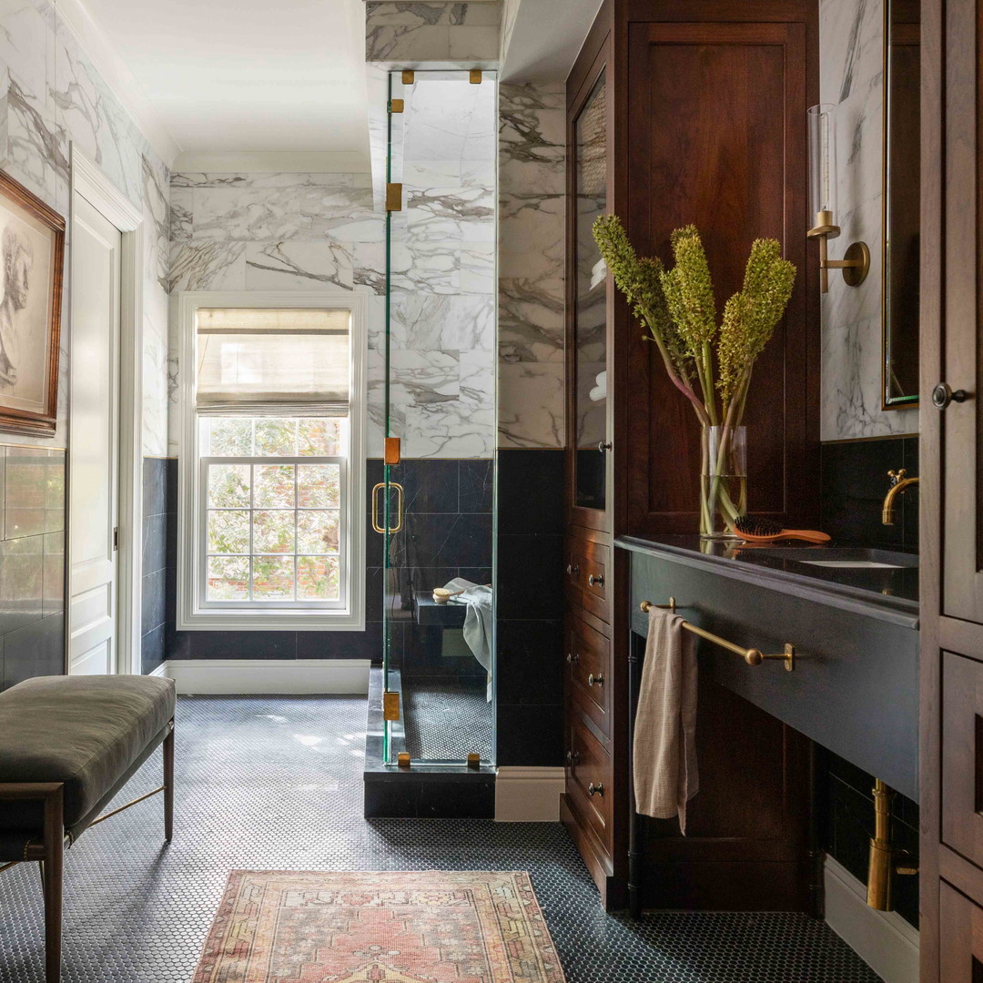 a bathroom with a sink, a mirror, and a rug