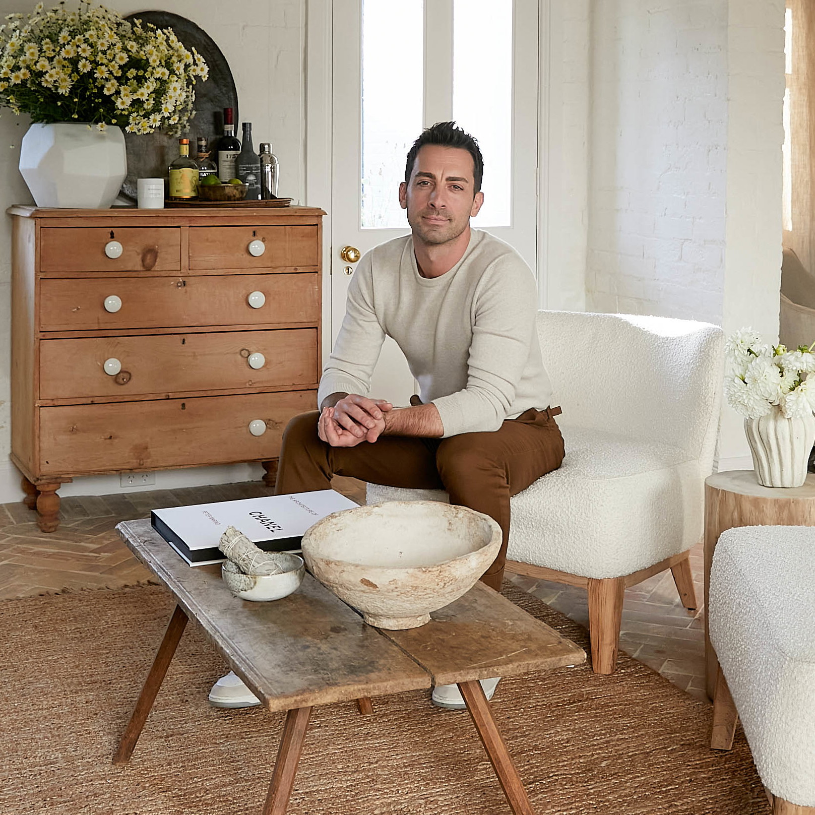 a man sitting on a chair in a living room