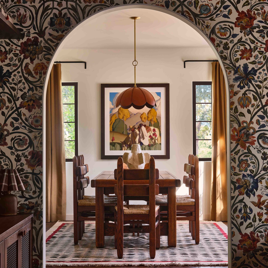 a dining room with a painting on the wall