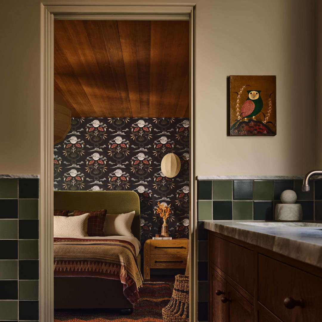 a room with a bed and a sink in it