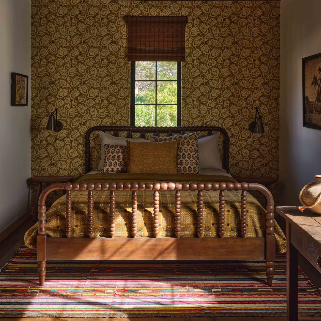 a bed room with a neatly made bed and a window