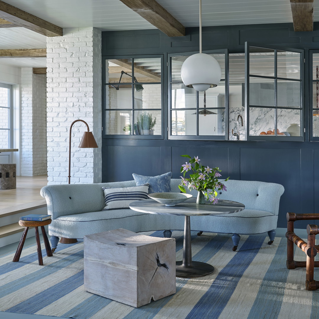 a living room filled with furniture and a large window