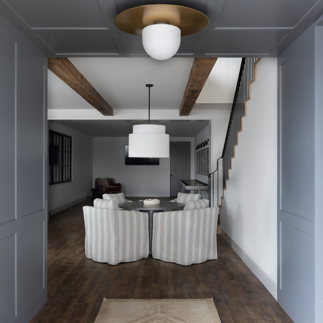 a living room filled with furniture and a white rug