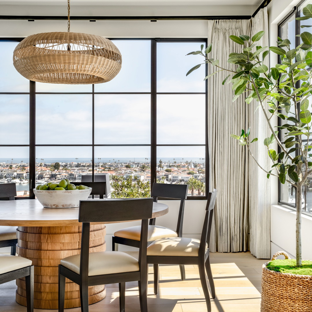 a dining room table and chairs with a view of the city