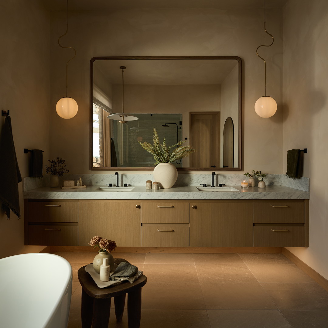 a bath room with a sink a mirror and a bath tub