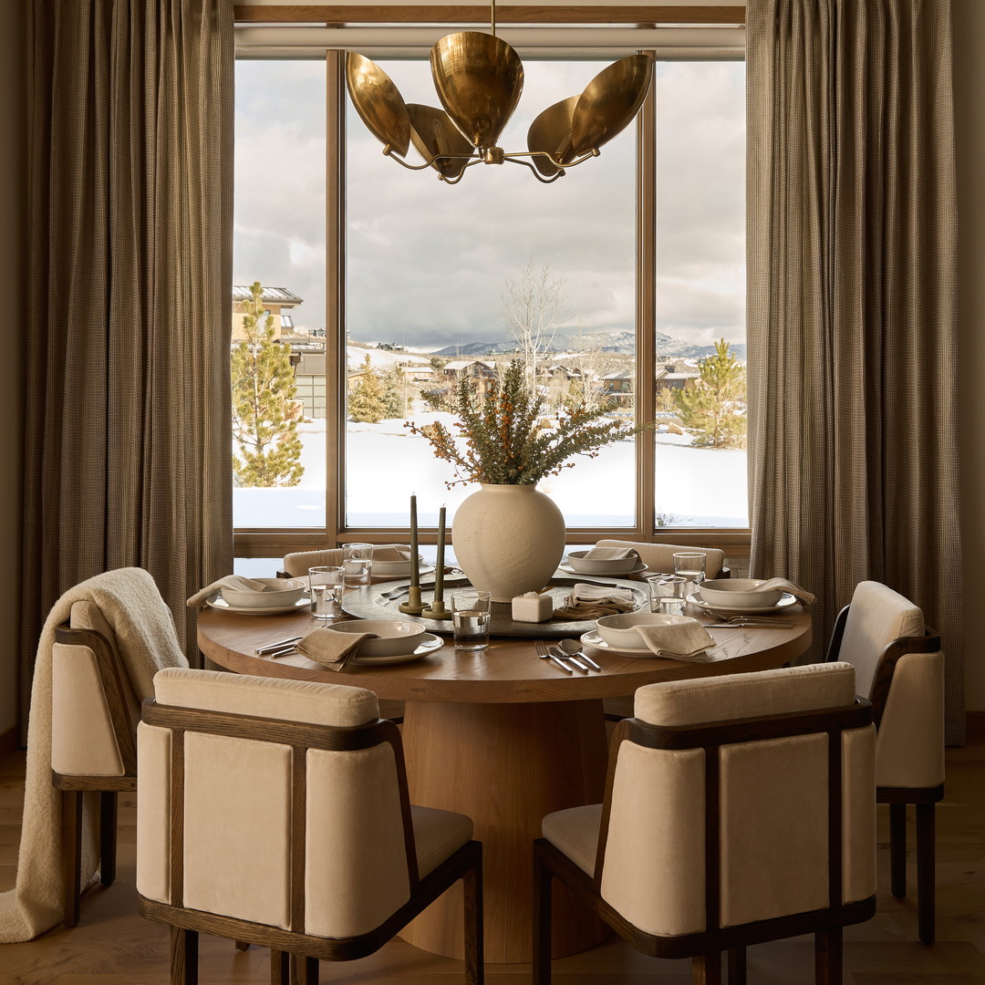 a dining room with a table and chairs