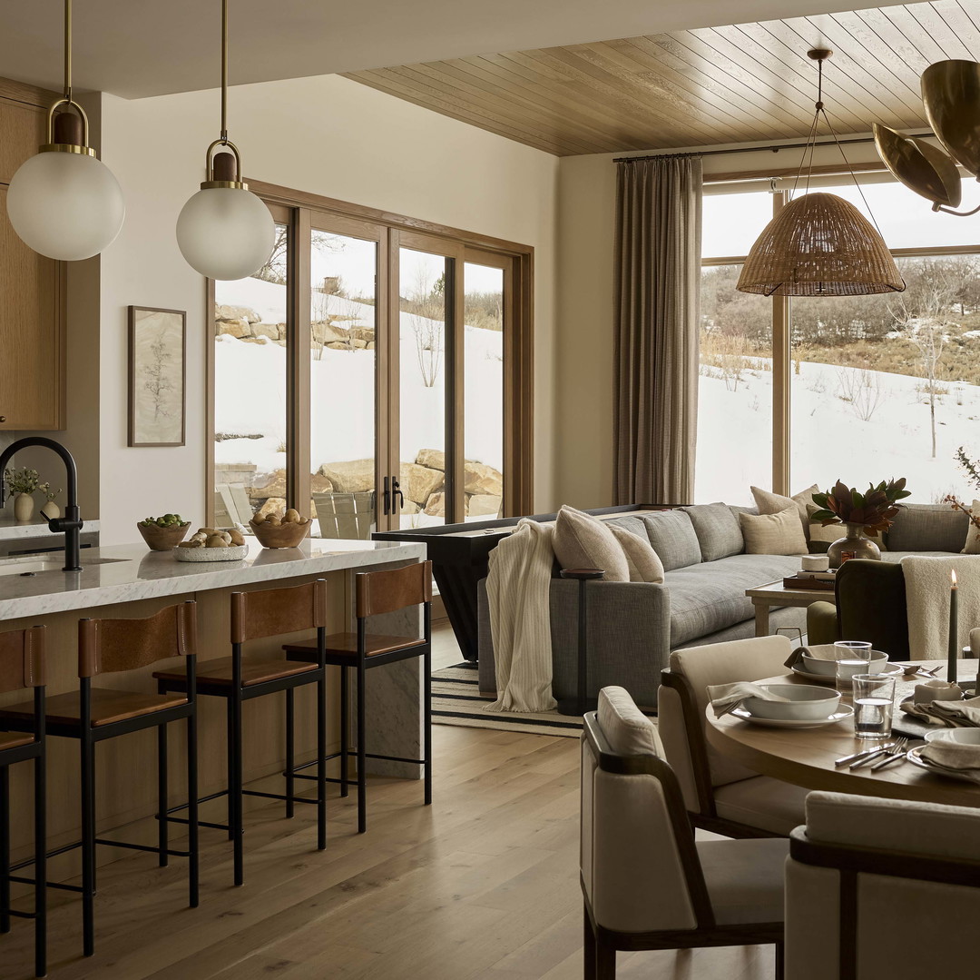 a living room filled with furniture and lots of windows