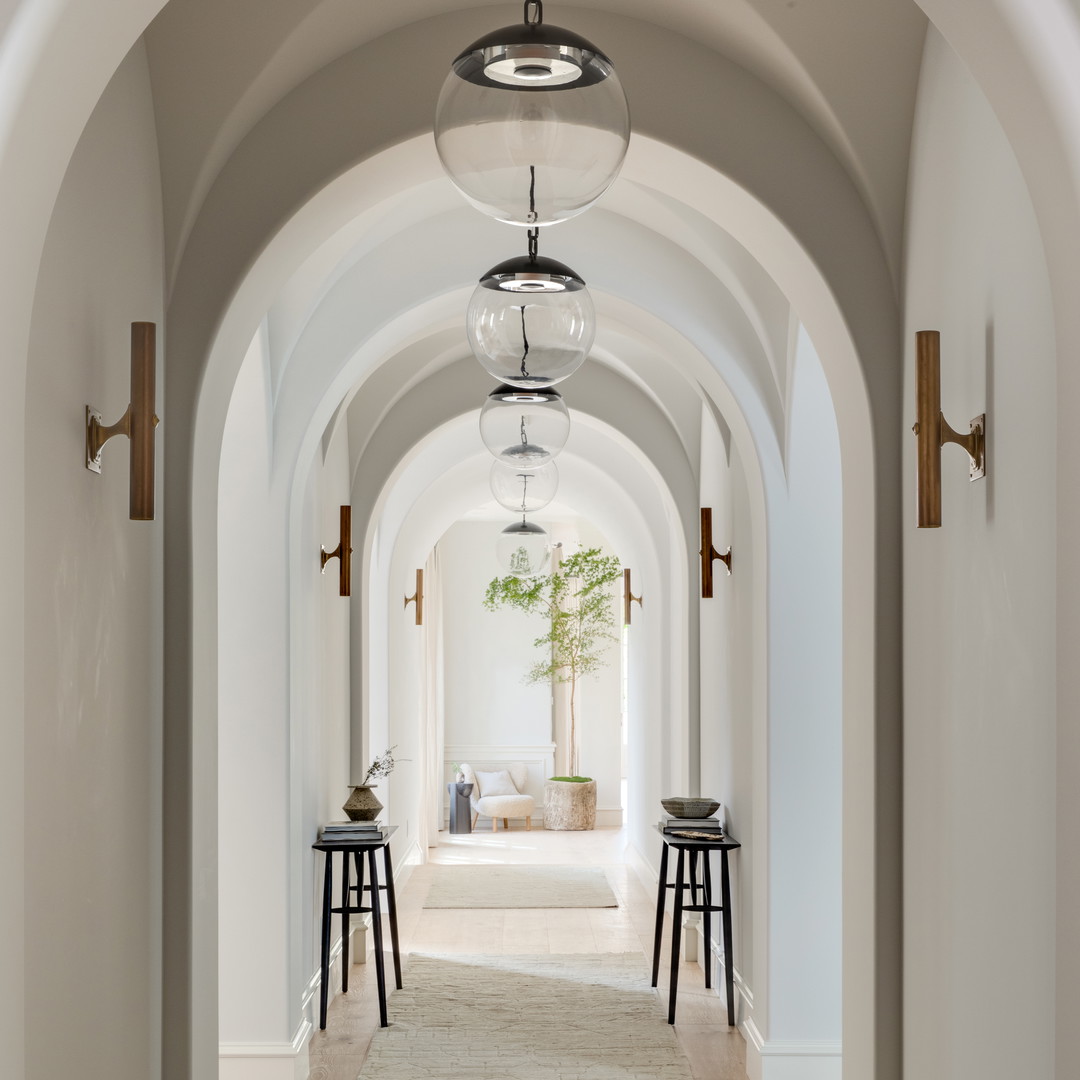 a long hallway with a light fixture hanging from the ceiling