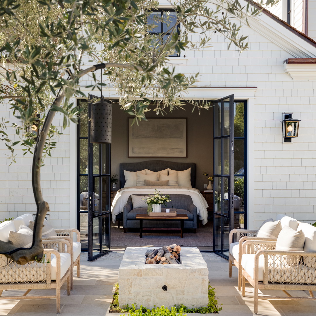 a bedroom with a bed and a patio