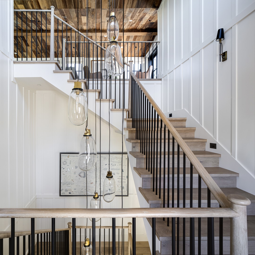 a stair case with a chandelier hanging from the ceiling