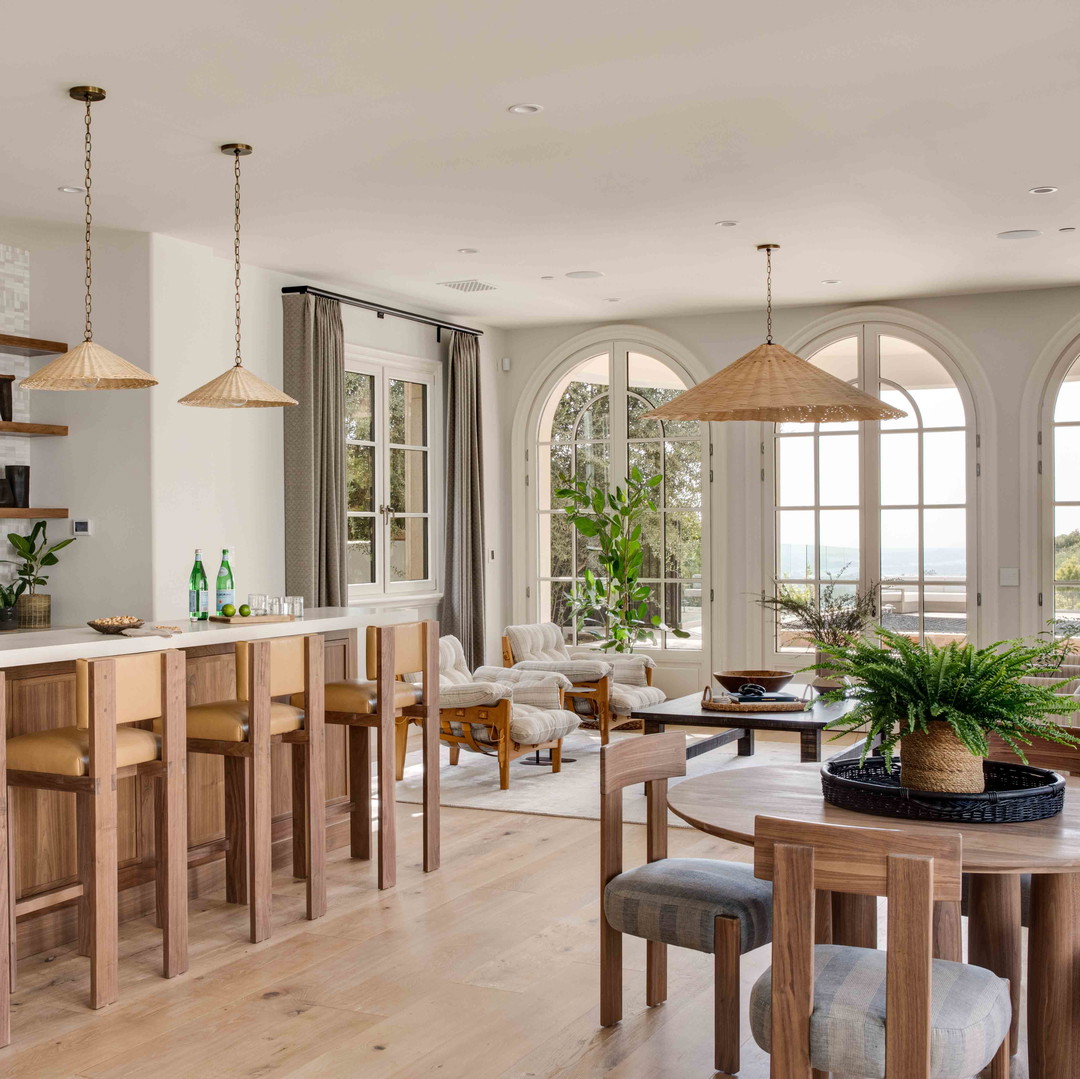 a living room with a bar and a dining room table