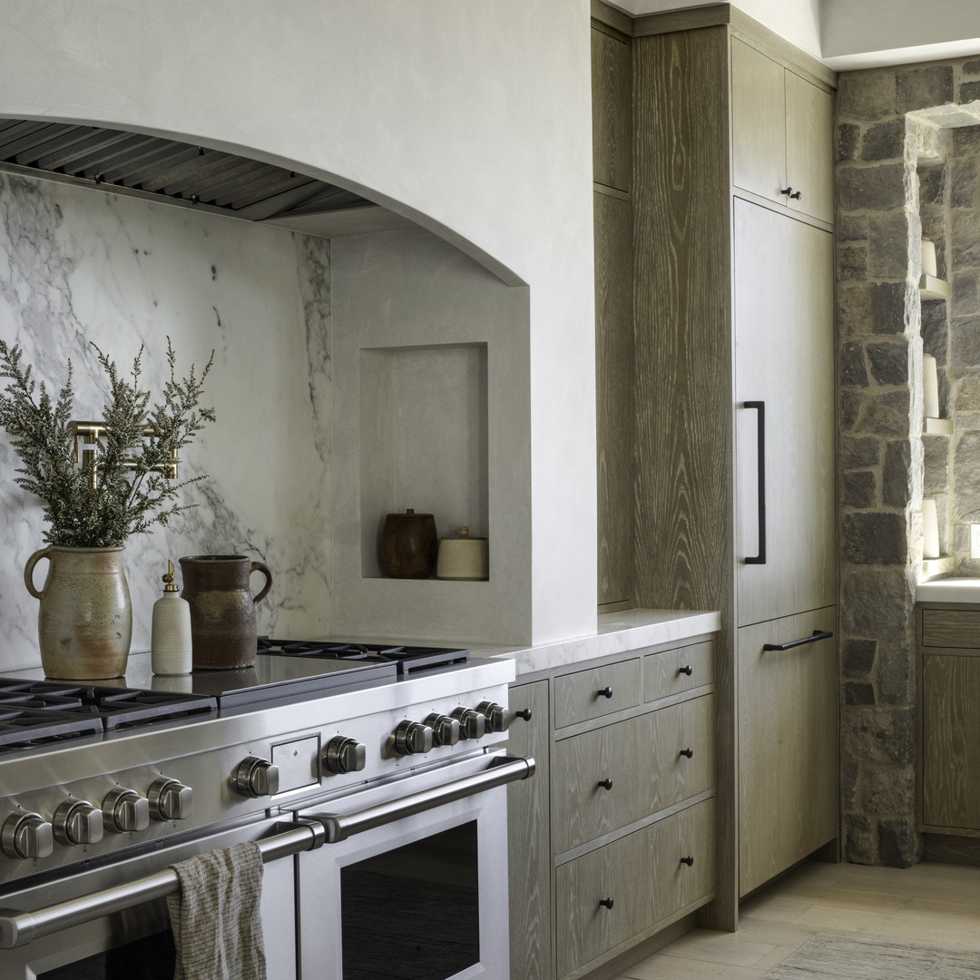 a kitchen with an oven, stove, and sink