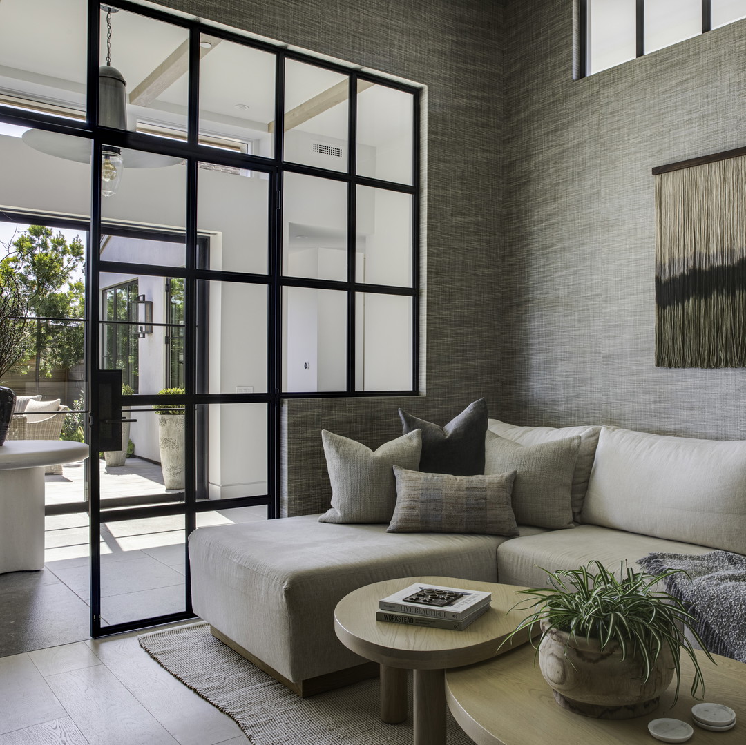 a living room filled with furniture and a large window