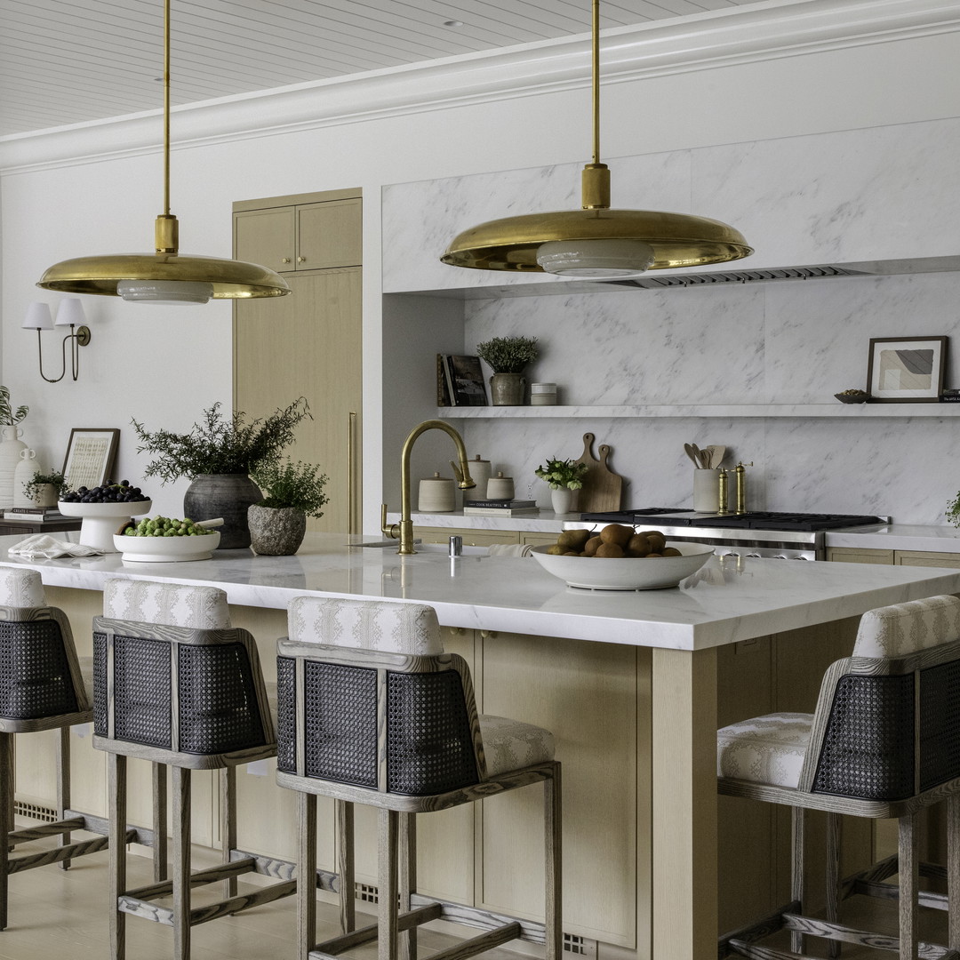 a large kitchen with a center island and bar stools