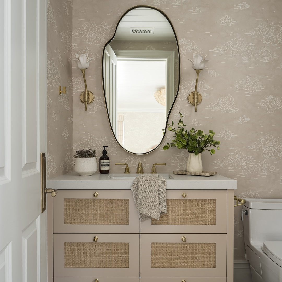 a bathroom with a mirror, sink, and toilet