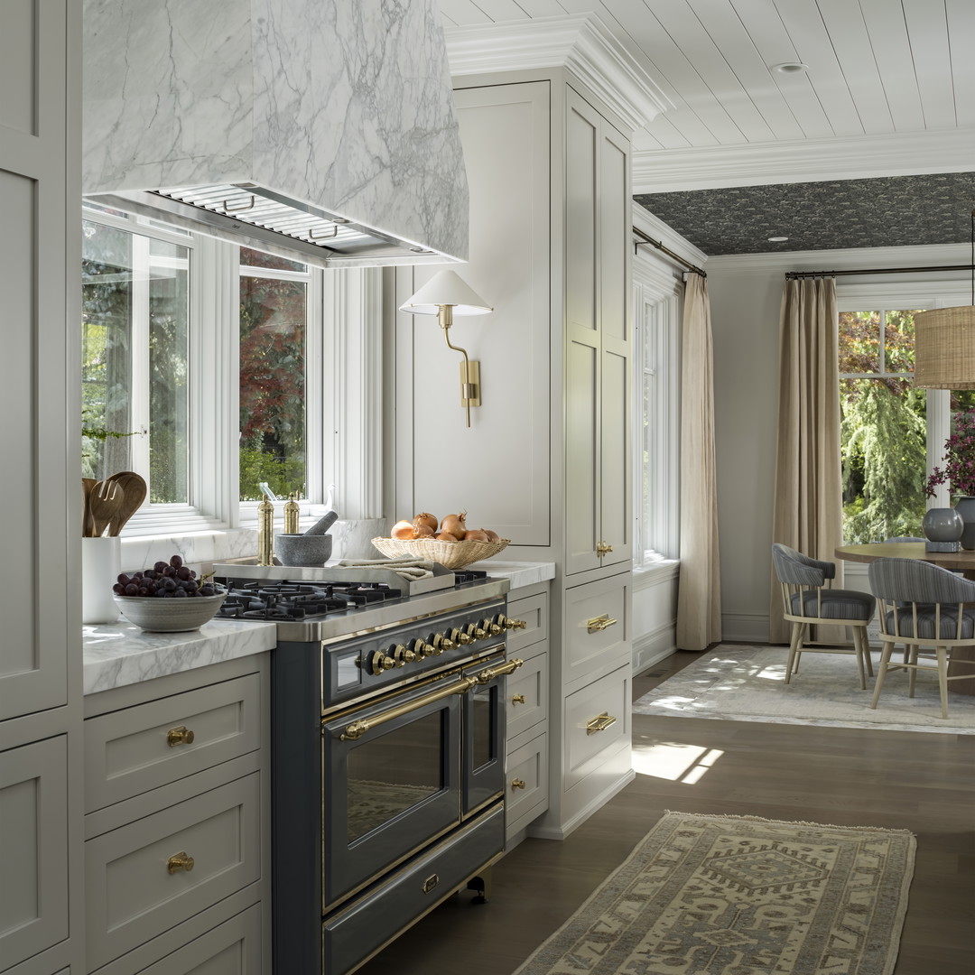 a kitchen with a stove top oven sitting next to a dining room table