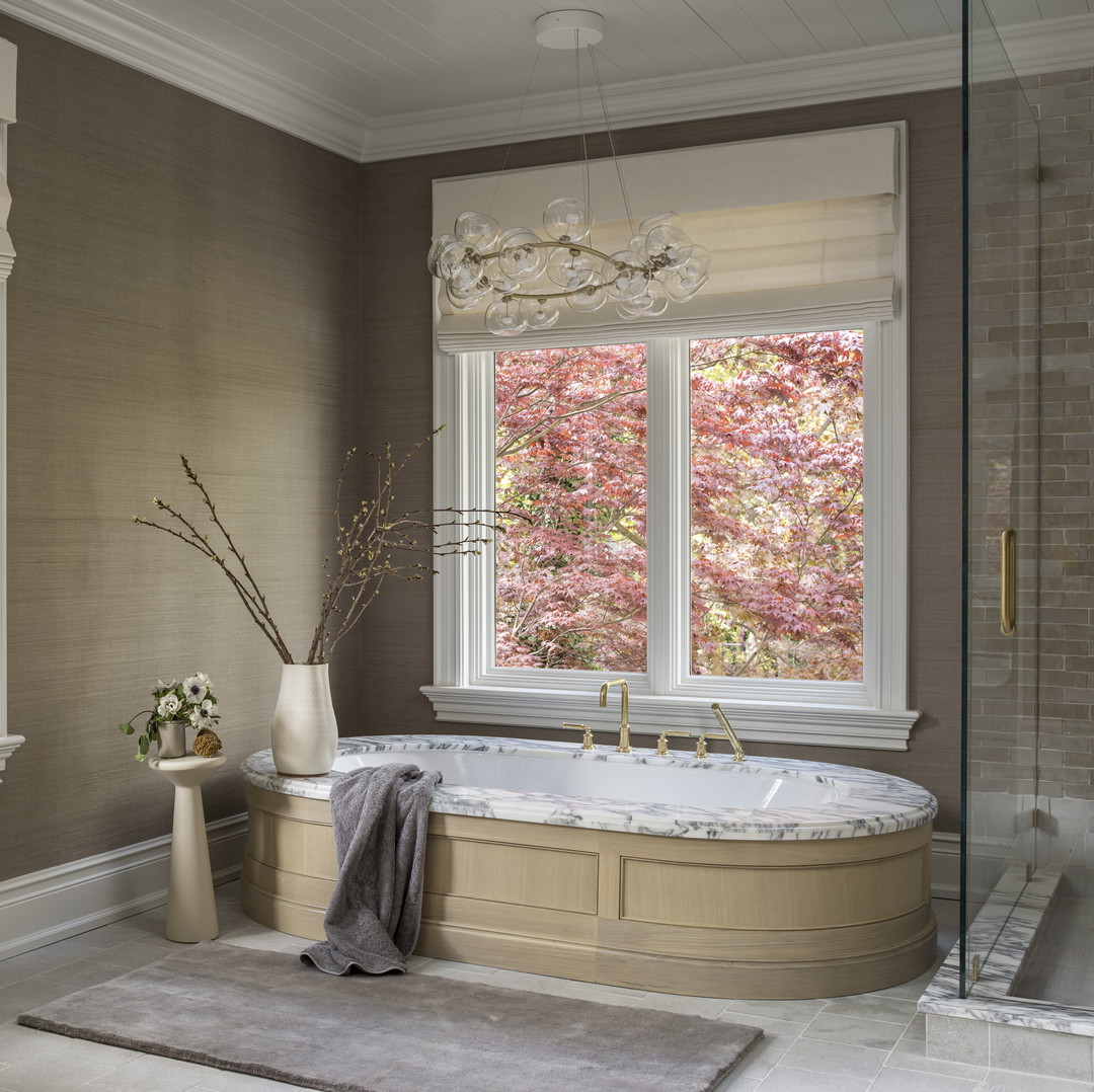 a bathroom with a large tub next to two windows