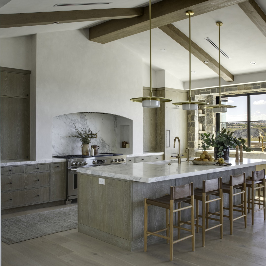 a kitchen with a large center island next to a window