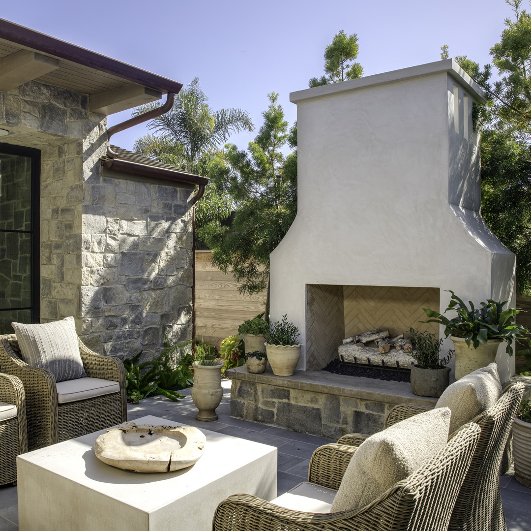 a patio with chairs and a fire place