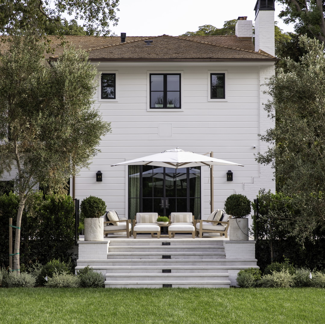 a large white house with a large lawn