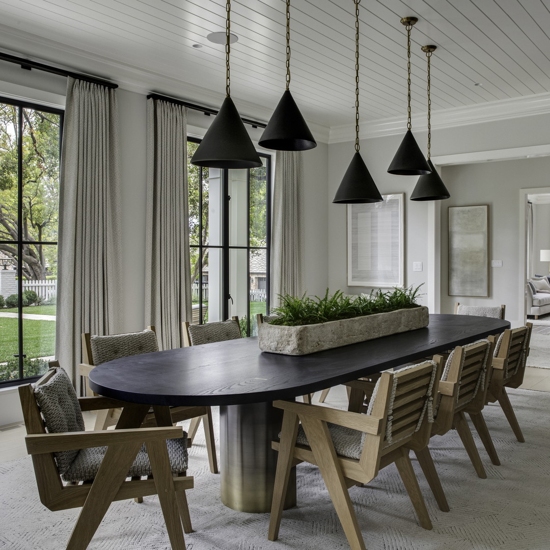 a dining room with a large table and chairs