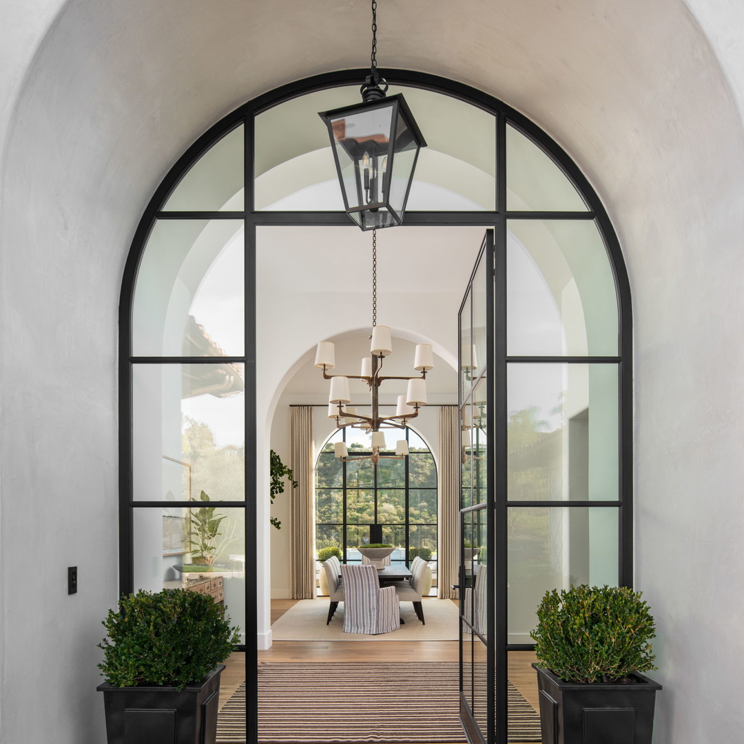 the entrance to a house with a large glass door