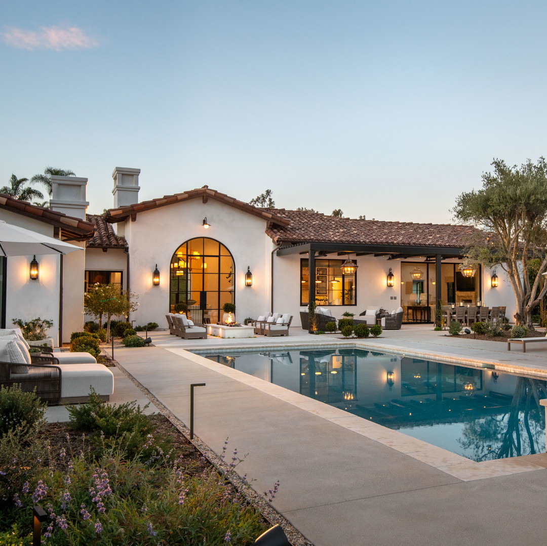 a house with a swimming pool and patio furniture