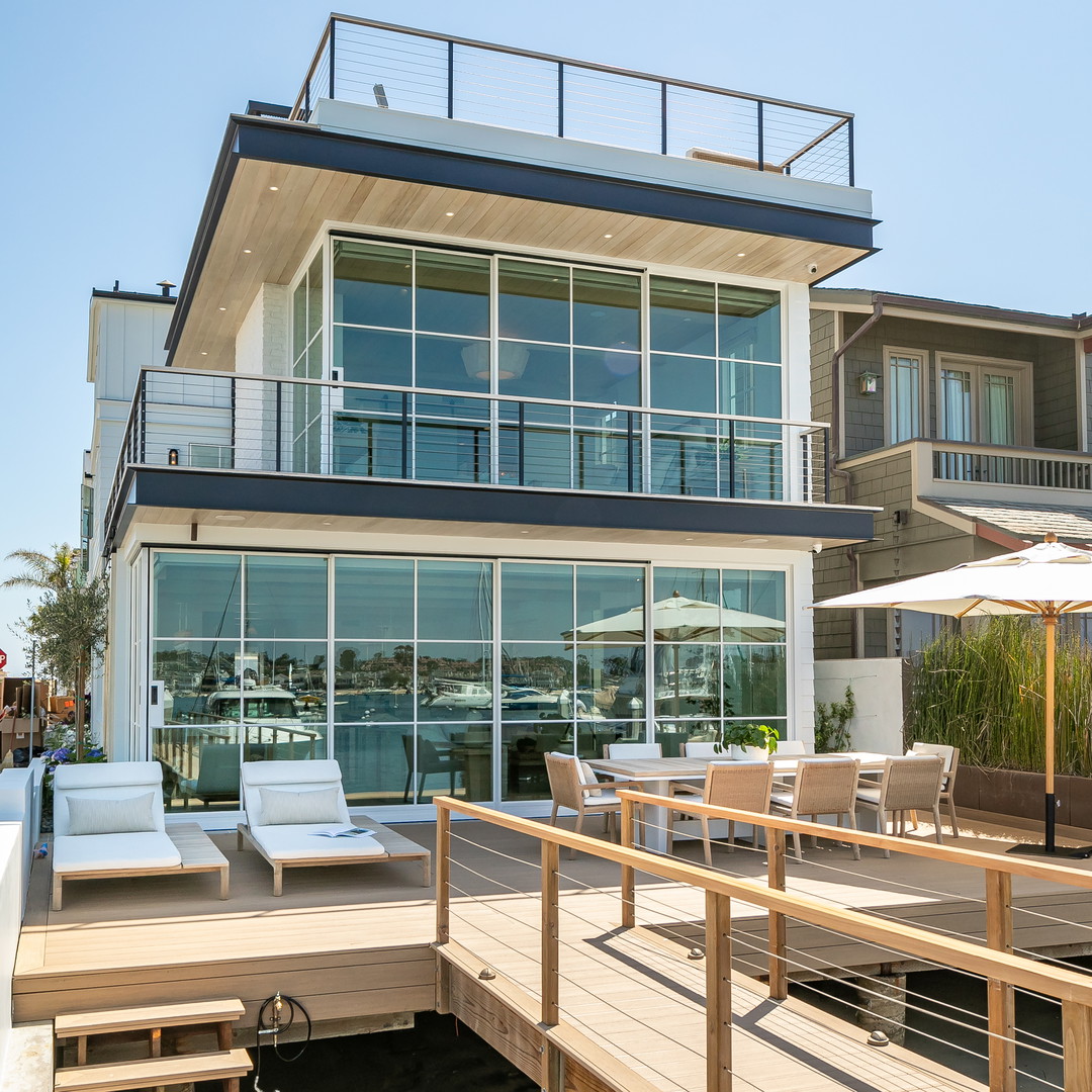 a large house with a deck and patio furniture