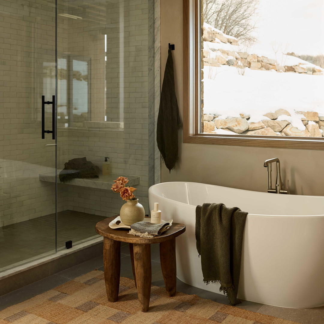 a bathroom with a large tub and a window