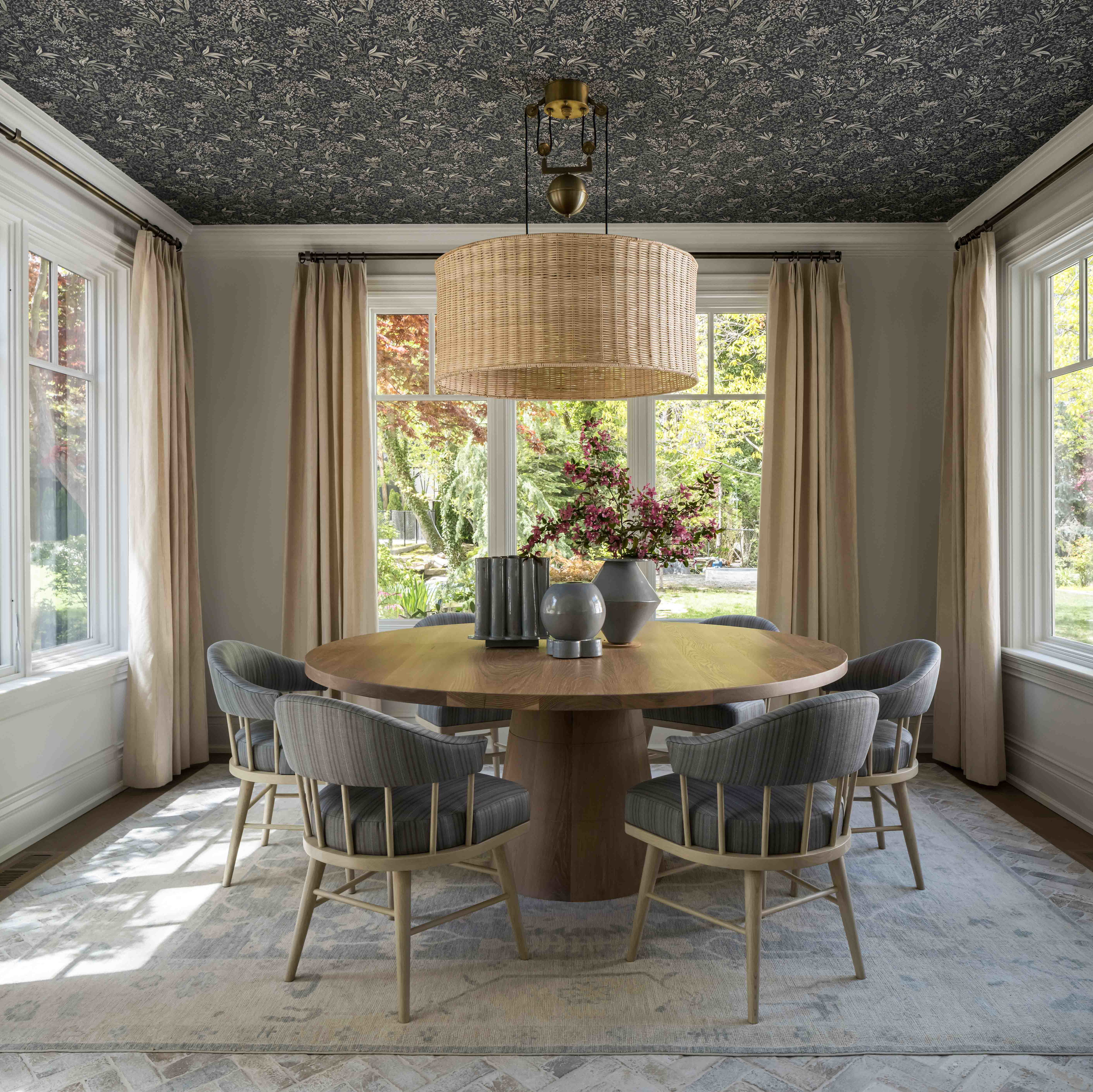 a dining room table surrounded by chairs and a chandelier