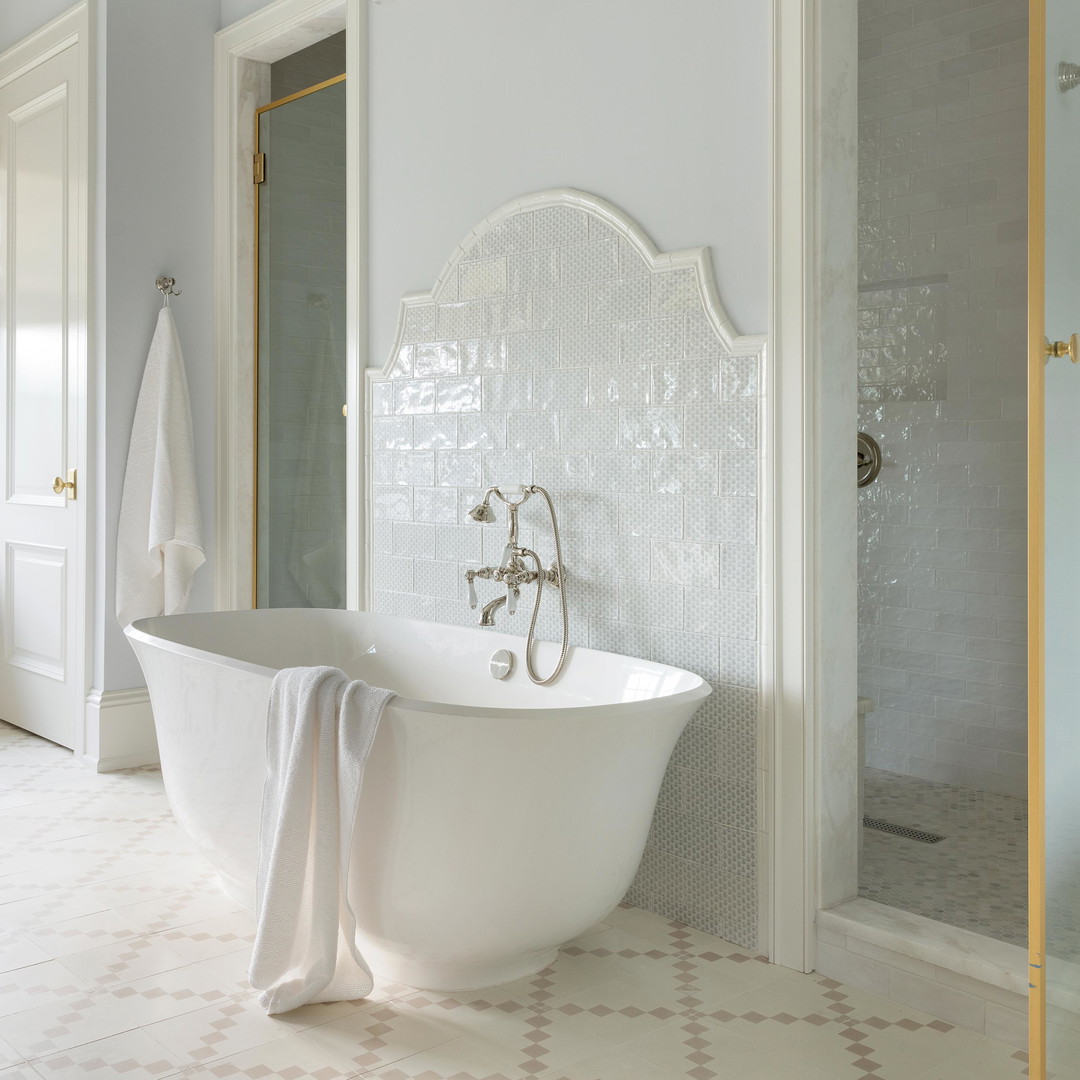 a white bath tub sitting next to a walk in shower