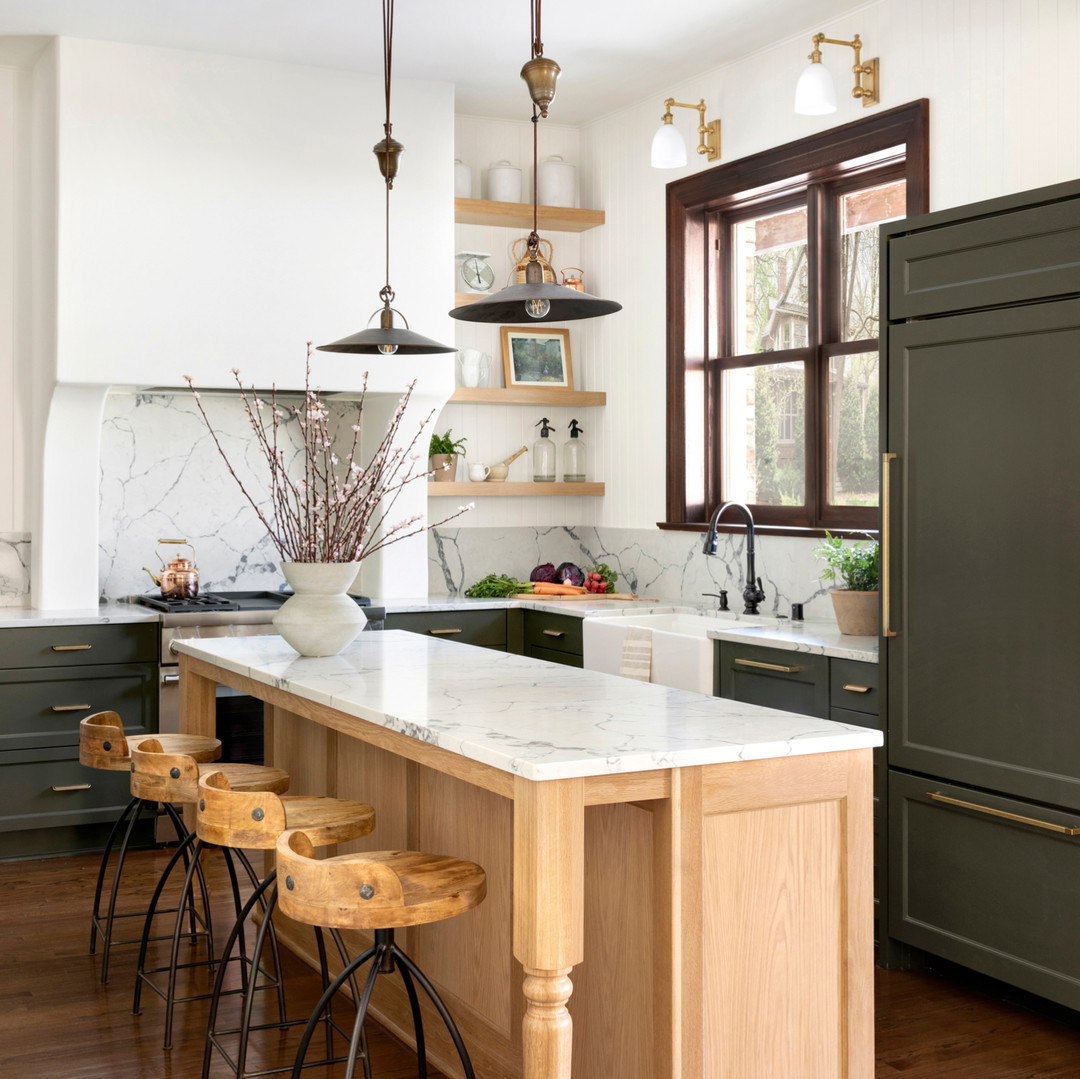 a kitchen with a marble counter top and wooden stools