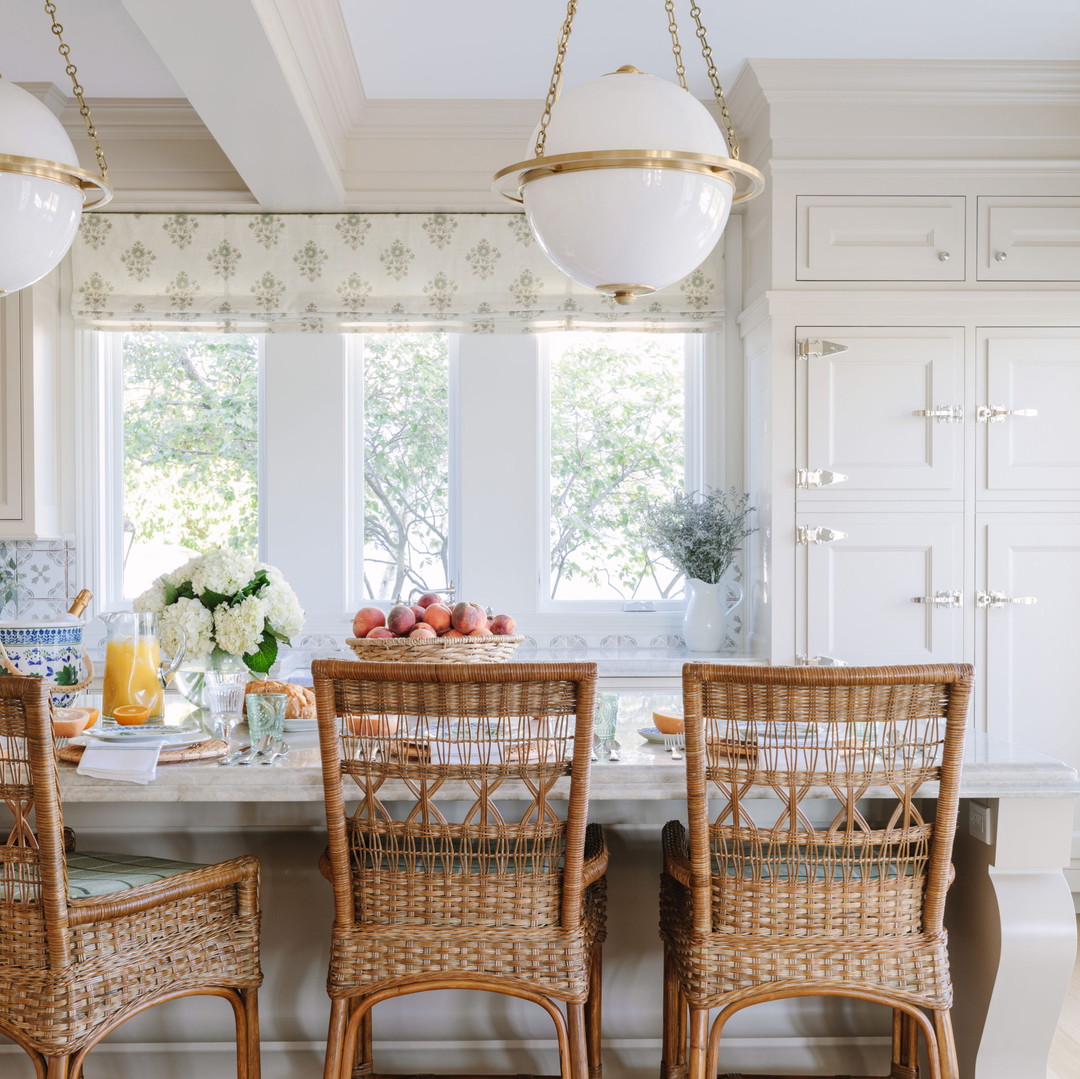 a kitchen with wicker chairs and a table