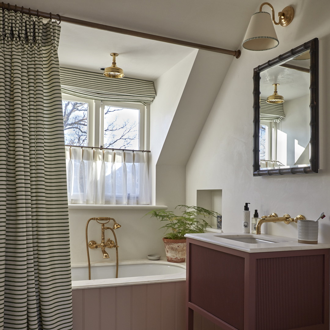 a bathroom with a tub, sink, and a window