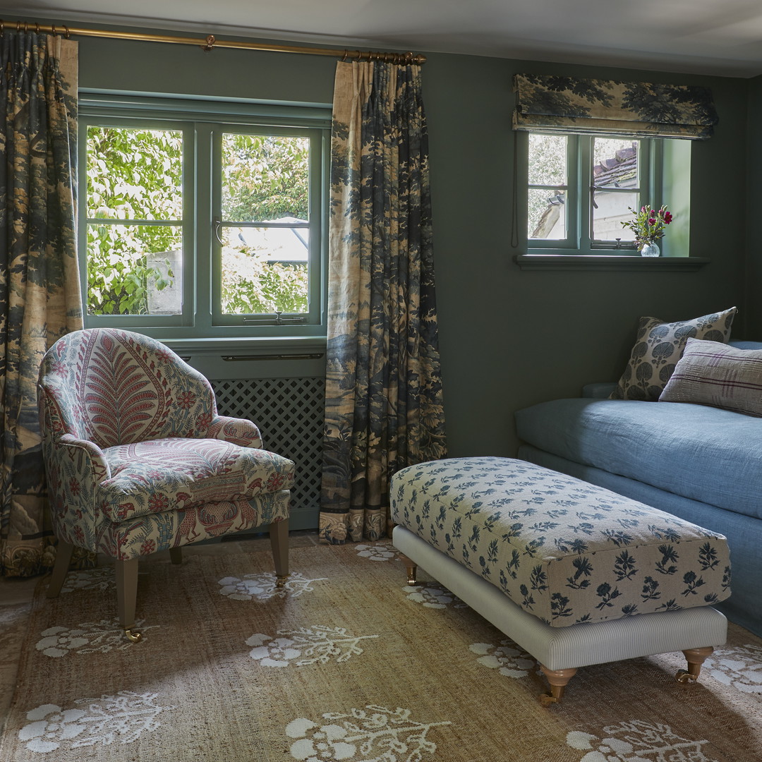 a living room with a couch, chair and window