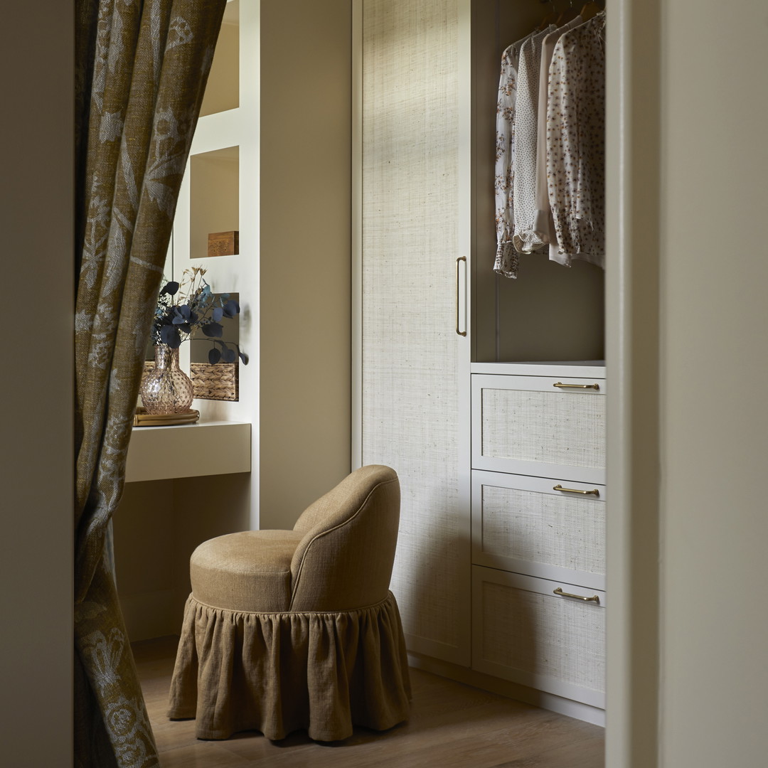 a bedroom with a chair and a closet