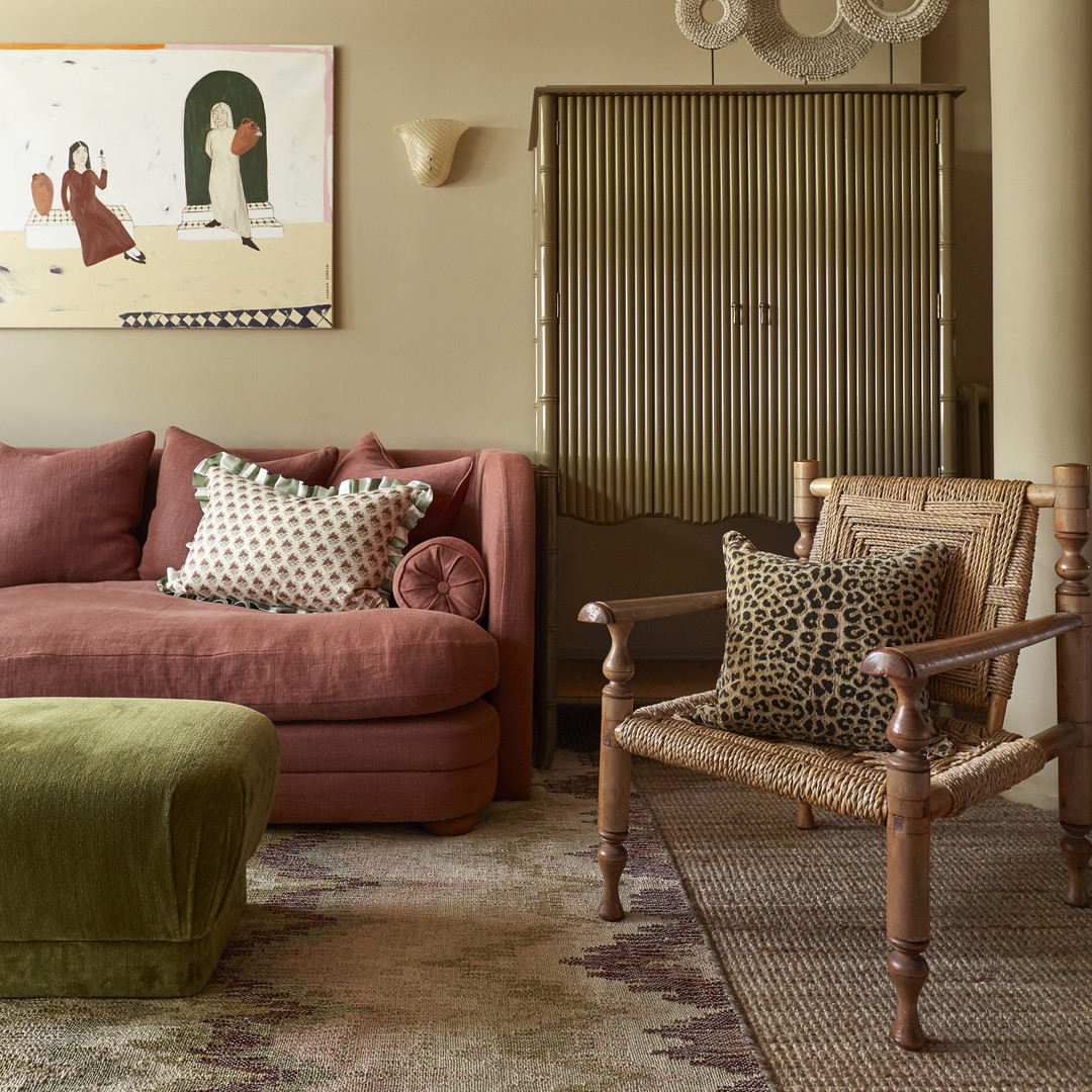 a living room filled with furniture and a painting on the wall