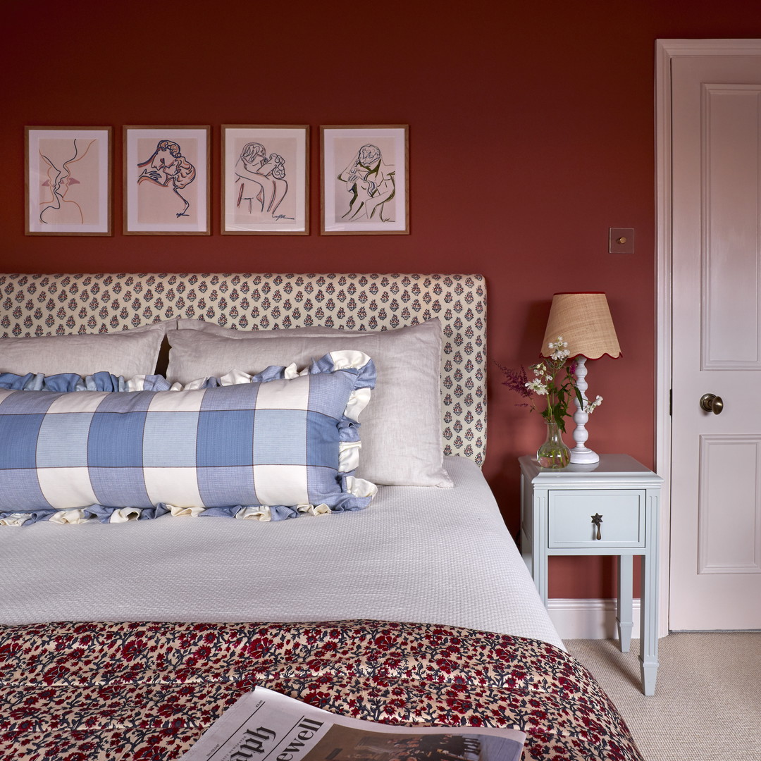 a bedroom with red walls and a white bed