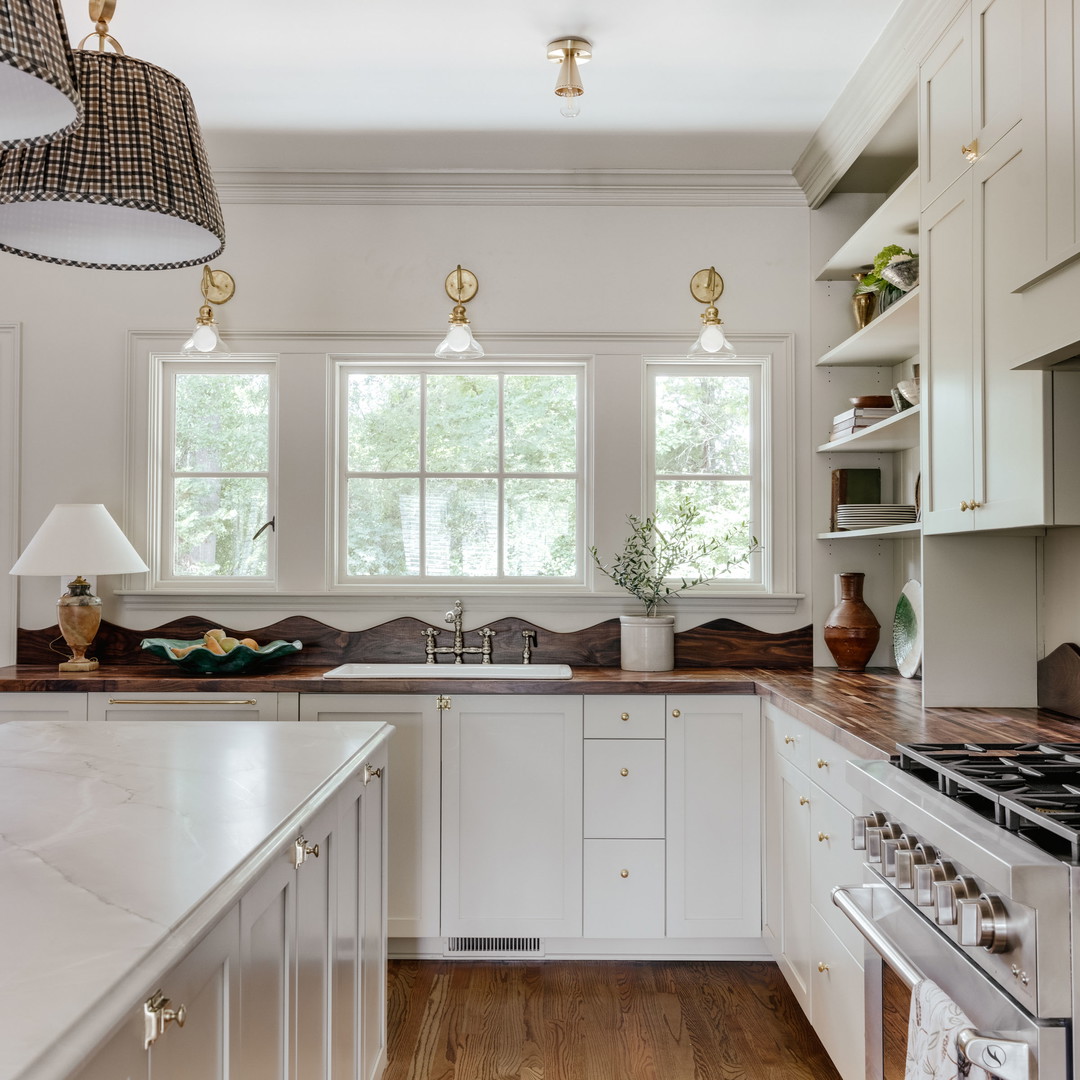 a kitchen with a stove top oven and a sink