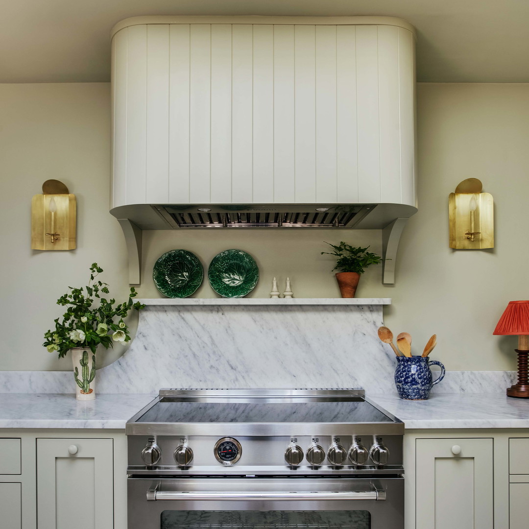 a stove top oven sitting inside of a kitchen