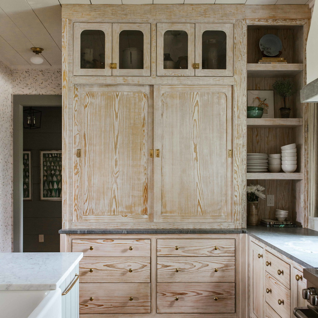 a kitchen with wooden cabinets and white counter tops