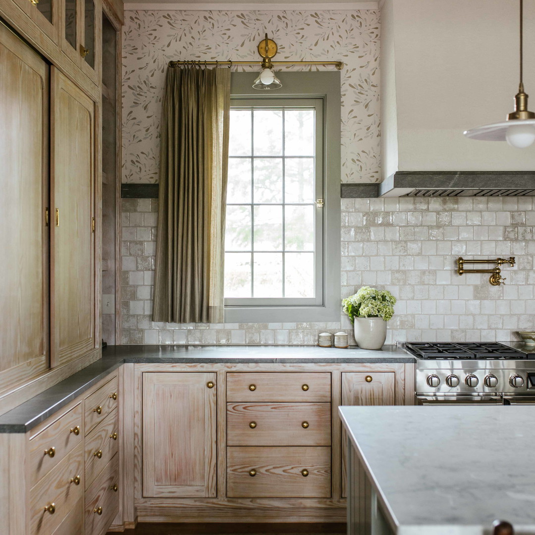 a kitchen with a sink, stove, cabinets and a window